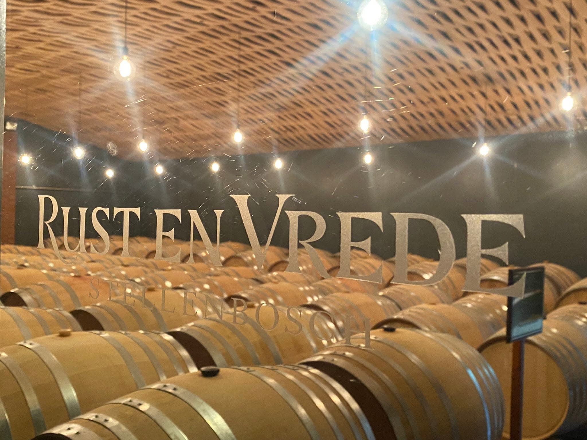 The Rust en Vrede barrel cellar under a lit brick vault